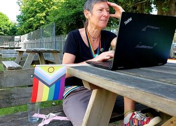 Language Assistant with Progress Flag working outside at college