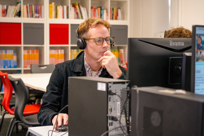 Principal William Baldwin sat at a computer in the newly refurbished Language Centre