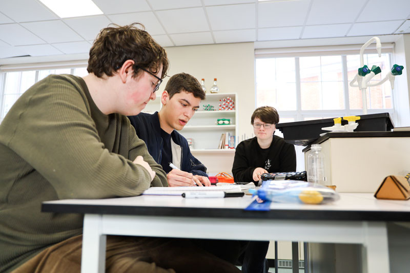 Noah, Finley and Harlan compare their calculations