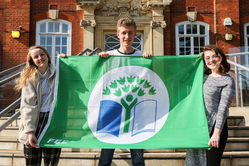 Students holding a Carbon Literacy flag