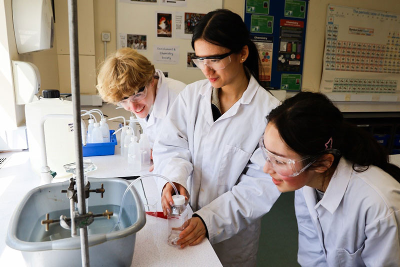 Sam, Carlyn and Lara check how much carbon dioxide gas is generated from their flour sample reacting with acid in the plastic bottle. 