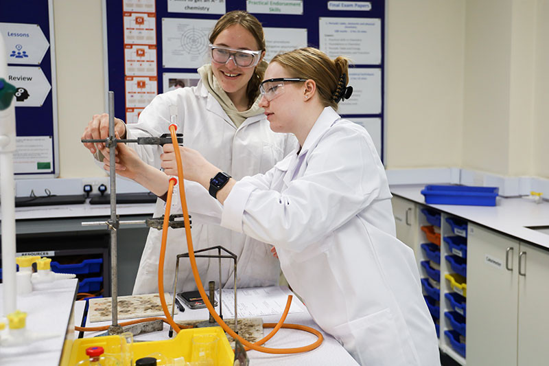 Juliana and Jess make sure their condenser is in the right position.