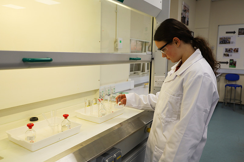 Lola adds her ethanoic anhydride from the fume hood.