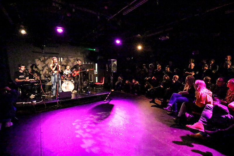 A band plays to an audience in the theatre 